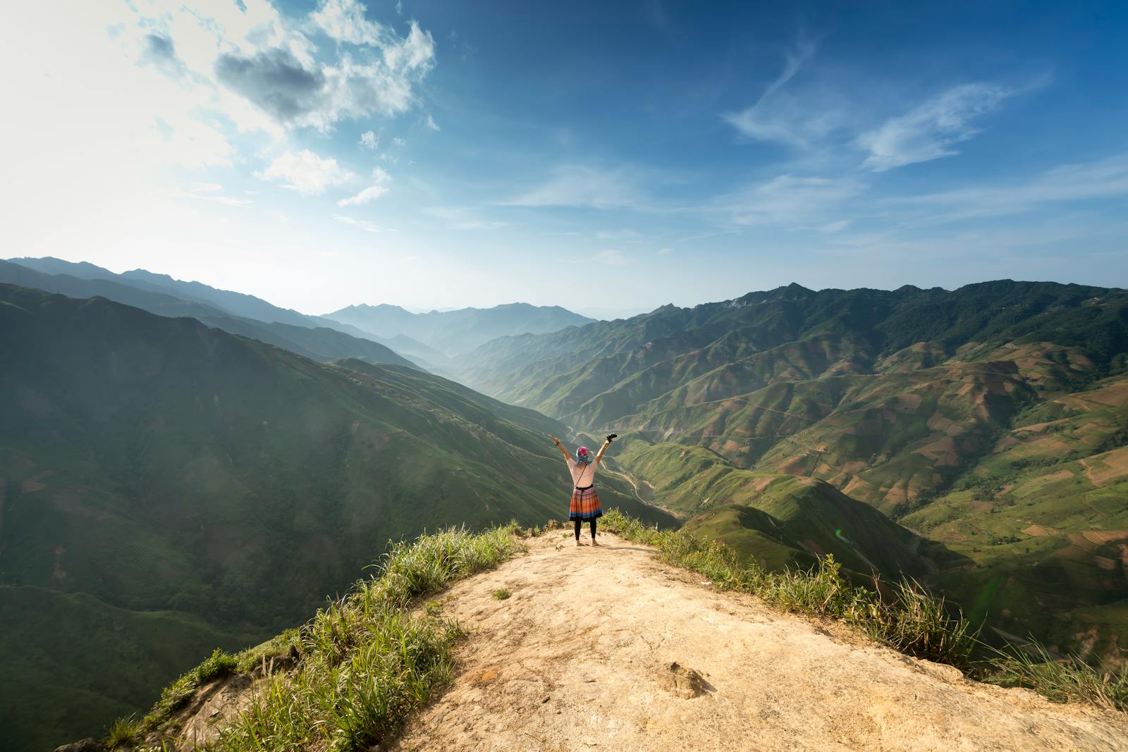 Photo of Person Standing On Top Of Mountain